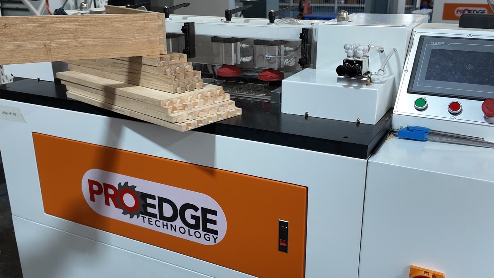 Finished dovetail joints on wood components staged on the machine