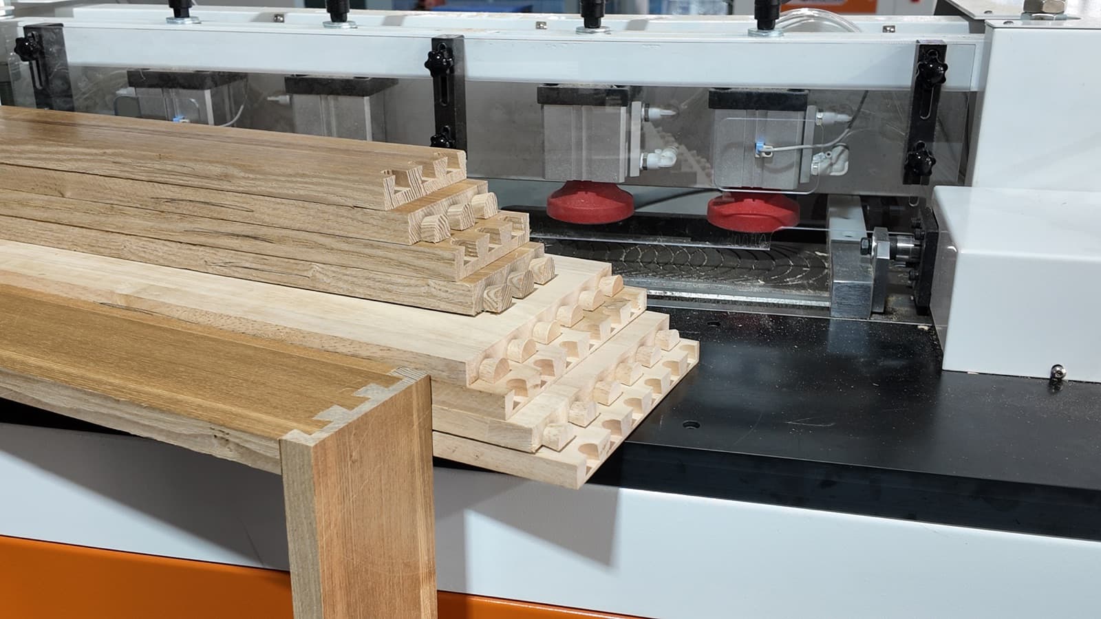 Close-up of machined dovetail joints on multiple wood components