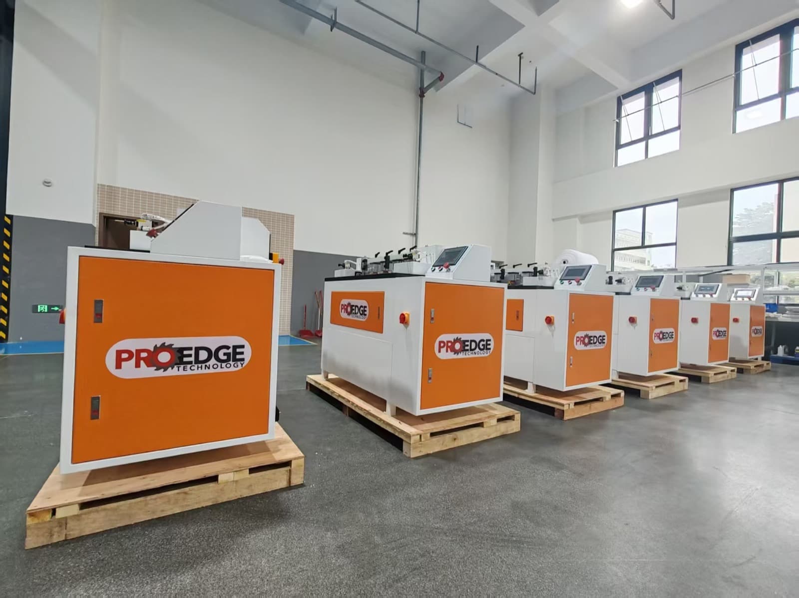 CNC Dovetail machines staged in a tall factory production bay