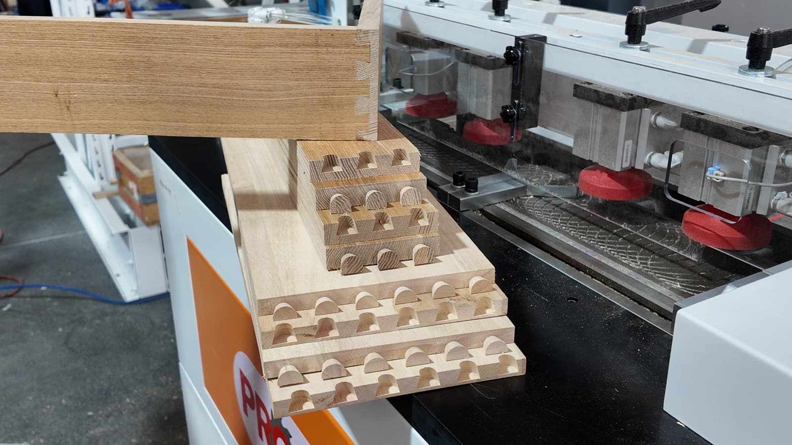 Uniform, equally spaced CNC-machined dovetail joints on a wood panel