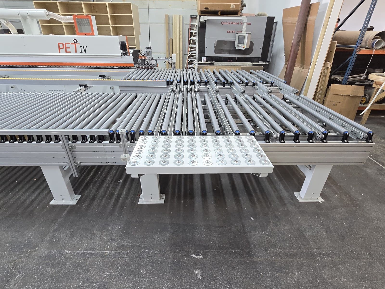 Long part support table with ball transfers mounted on the conveyor edge