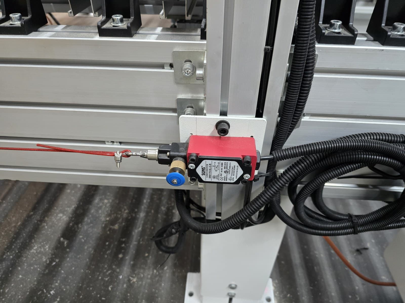 Safety pull-cord switch mounted on the conveyor frame